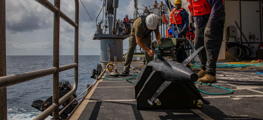 Sailors and civilian mariners launch a Wave Glider Unmanned Surface Vehicle from the fantail of USNS Burlington as a part of the UNITAS U.S. Naval Forces Southern Command/U.S. 4th Fleet Unmanned Integration Campaign. 