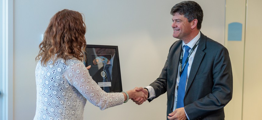 DC3 Director Jude Sunderbruch, shown here accepting an award from the Australian Federal Police on September 21 2023, warned that AI vs AI cyber conflict is coming.