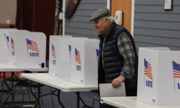 Voters cast their ballots at a polling location setup at Winnacunnet High School on January 23, 2024 in Hampton, N.H.