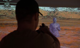 A Green Beret with 10th Special Forces Group (Airborne) fires at a target in the VirTra simulator on Fort Carson, Colorado, Feb. 2, 2024.