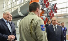 Russian President Vladimir Putin (R) speaks with a Roscosmos employee during a visit at the Vostochny cosmodrome on April 12, 2022.