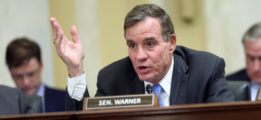 Virginia Democrat Sen. Mark Warner, shown here at a November 2023 hearing, says that the Biden administration has been "too timid" in its reading of court rulings around federal agency contacts with social media companies.