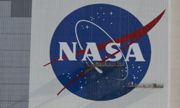 Painters refurbish the NASA logo on the Vehicle Assembly Building at the Kennedy Space Center in Florida in Florida on May 29, 2020.