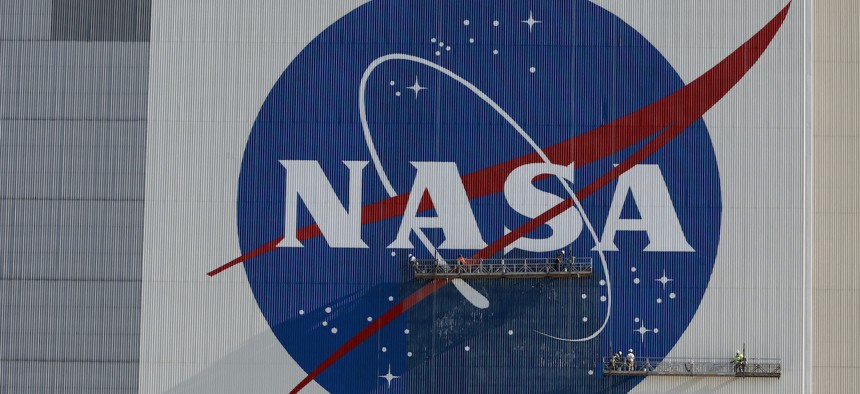 Painters refurbish the NASA logo on the Vehicle Assembly Building at the Kennedy Space Center in Florida in Florida on May 29, 2020.