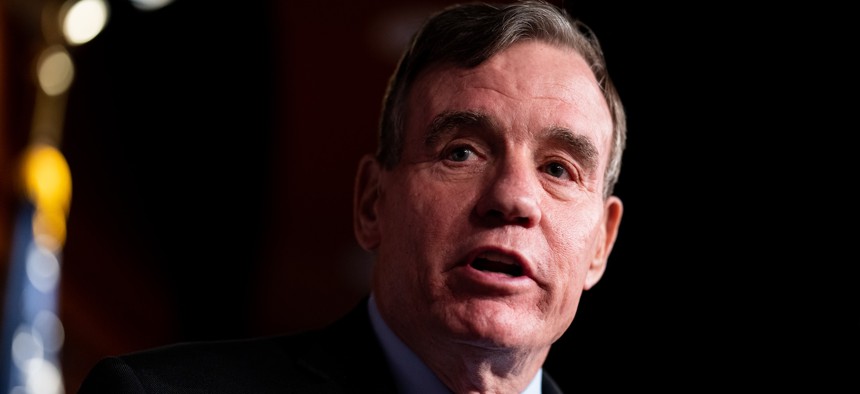 Sen. Mark Warner, shown here at a news conference on March 14. 2024, is looking to incentivize cybersecurity upgrades in the health care industry. 