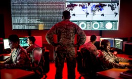 Capt. Taiwan Veney, cyber warfare operations officer, watches members of the 175th Cyberspace Operations Group analyze log files and provide a cyber threat update at Warfield Air National Guard Base, Middle River, Md., June 3, 2017.