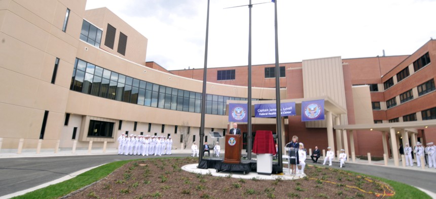 Retired Capt. James A. Lovell, left, a NASA astronaut, speaks to more than 750 guests at the official opening of the Capt. James A. Lovell Federal Health Care Center in Chicago.