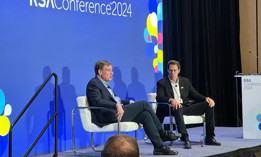 Sen. Mark Warner, D-Va. (L) speaks with NightDragon Founder and CEO Dave DeWalt (R) at the 2024 RSA conference in San Francisco, California.