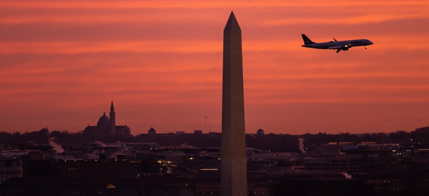 A  plane flies past the Washington Monument in Washington