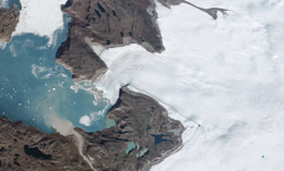 Newly calved icebergs, light-colored sediment carried by meltwater, and a handful of blue ponds on the ice are all signs of the heat wave visible in this September 4, 2022, PlanetScope image of a glacier on Greenland’s west coast.