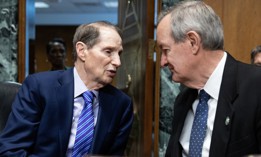 Chairman Ron Wyden, D-Ore., left, and ranking member Sen. Mike Crapo, R-Idaho, talk before a Senate Finance Committee hearing. The lawmakers introduced legislation Wednesday aimed at improving the unemployment insurance program.