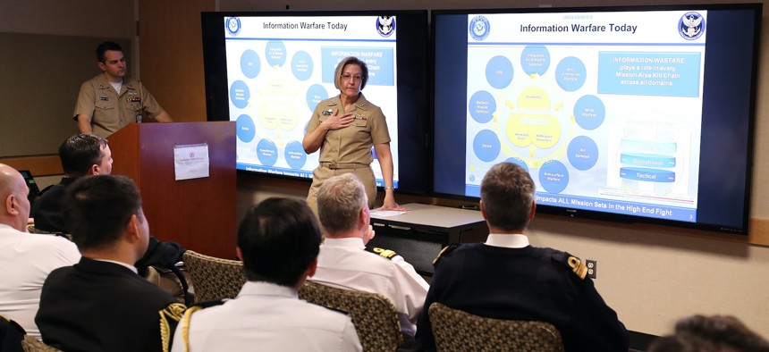Vice Adm. Kelly Aeschbach, commander of Naval Information Forces, discusses Navy Information Warfare missions and priorities with allied and partner naval attachés during a visit to the Pentagon Feb. 2, 2023.