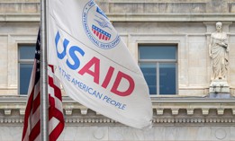 Flags fly outside USAID's headquarters in Washington, D.C. The agency is contracting with IBM to supply cybersecurity support services for U.S. allies.