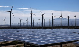 A wind farm abuts a solar array near Palm Springs, Calif. Permitting for energy projects is often cumbersome, officials say, and a new government report suggests technology could help.
