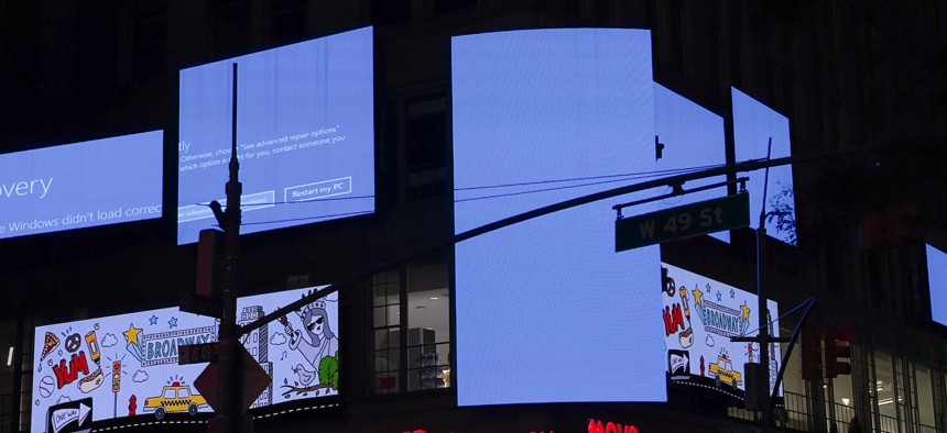 Digital billboards in New York City's Times Square rebooting after an error in a Crowdstrike software knocked Windows-based systems offline on July 19, 2024. The company has traced the outage to the source in a preliminary incident report.