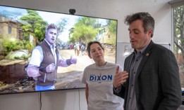 Onetime Silicon Valley congressional candidate Peter Dixon (R) and communications director, Taylor Hebble, talk with other staffers as a campaign video using AI generated content plays. The FCC is considering a rule to require the identification of AI-generated content in political ads on TV and radio.