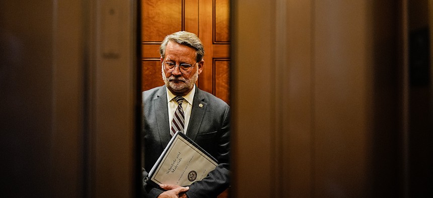 Sen. Gary Peters, D-Mich, shown here departing the Senate chamber after a vote on July 31, 2024, is co-sponsor of a bill that would harmonize various federal agency cybersecurity rules to support easier compliance.