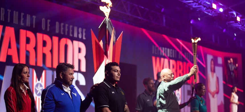 The torch bearer and representatives from each competing team participate in the cauldron lighting ceremony kicking off the 2024 Department of Defense Warrior Games at ESPN Wide World of Sports Complex in Orlando, Florida, June 22, 2024.