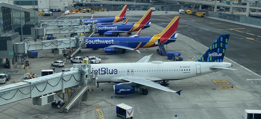 Aircraft at the gate at New York City's LaGuardia Airport. Federal regulators are proposing new requirements for aviation cybersecurity.