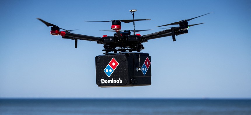 A drone delivers pizza to a beach as part of a 2020 test in the Netherlands. New U.S. spectrum rules supporting drone navigation will give operators access to communications to support more use cases of this kind in the future.