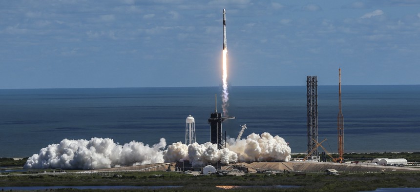 SpaceX’s Falcon 9 rocket with the Dragon spacecraft atop takes off from Launch Complex 39A at NASA's Kennedy Space Center on October 05, 2022 in Cape Canaveral, Florida. A NASA official said recently that continued engagement with commercial contractors is essential to the U.S. space program.