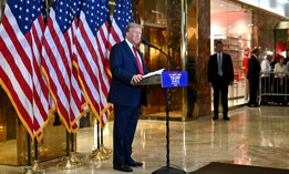 Former president and current Republican presidential candidate Donald Trump speaks to reporters at Trump Tower in New York City on Sept. 26, 2024. The Justice Dept. indicted three Iranian cyber operatives for allegedly hacking email accounts associated with Trump's campaign.