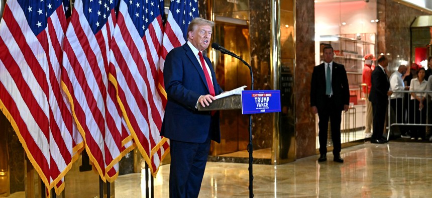 Former president and current Republican presidential candidate Donald Trump speaks to reporters at Trump Tower in New York City on Sept. 26, 2024. The Justice Dept. indicted three Iranian cyber operatives for allegedly hacking email accounts associated with Trump's campaign.