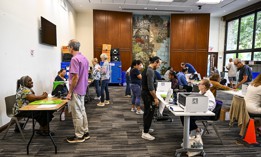 Voters cast their ballots in a public library in Coral Gables, Fla. on Oct. 21. Cyber researchers are keeping close tabs on efforts by foreign adversaries to influence the election using AI-generated content.