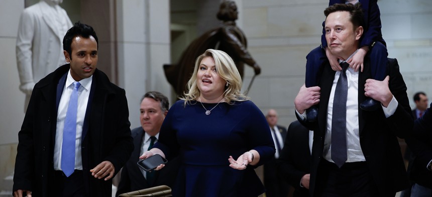 Tesla CEO Elon Musk (R), Co-Chair of the newly announced Department of Government Efficiency (DOGE) carries his son on his shoulders at the U.S. Capitol following a meeting with businessman Vivek Ramaswamy (L), Co-Chair of the newly announced Department of Government Efficiency, Rep. Kat Cammack (C), and other members of the U.S. Congress on December 05, 2024 in Washington, DC.