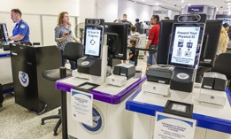 ID scanners at a TSA checkpoint at Miami International Airport. Some lawmakers are seeking investigation into the security and cost effectiveness of such biometric devices.