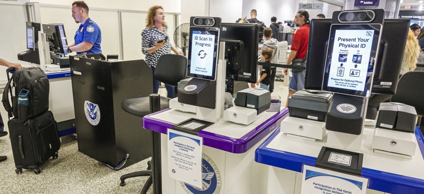 ID scanners at a TSA checkpoint at Miami International Airport. Some lawmakers are seeking investigation into the security and cost effectiveness of such biometric devices.