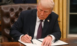 US President Donald Trump signs an executive order in the Oval Office of the WHite House in Washington, DC, on January 20, 2025.