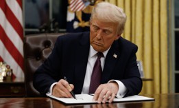 President Donald Trump signs an executive order after being sworn in for his second term. Grant recipients are worried about possible federal funding freezes, including in the tech sector.