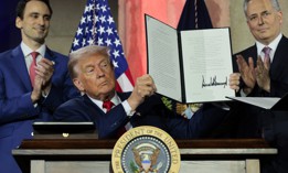 U.S. President Donald Trump displays a signed executive order during the "Winning the AI Race" summit hosted by All‑In Podcast and Hill & Valley Forum at the Andrew W. Mellon Auditorium on July 23, 2025 in Washington, DC. Trump signed executive orders related to his Artificial Intelligence Action Plan during the event.