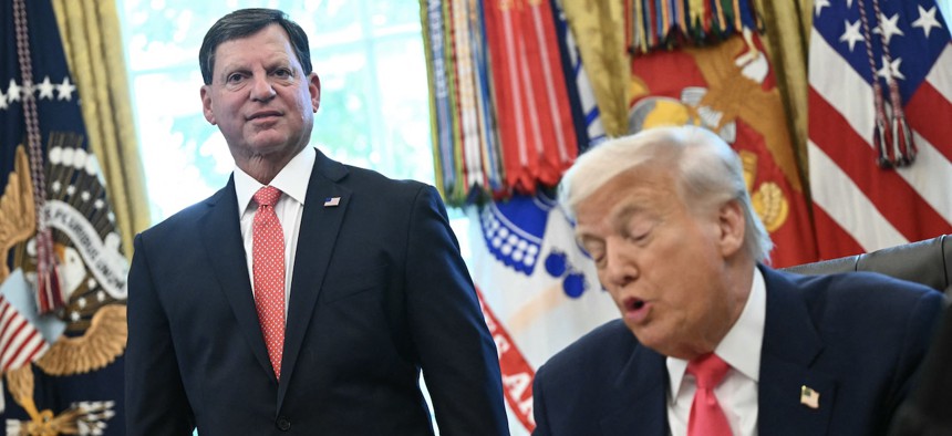 Social Security Commissioner Frank Bisignano looks on as President Donald Trump speaks prior to signing a presidential proclamation honoring the 90th anniversary of the Social Security Act in the Oval Office on Aug. 14, 2025.