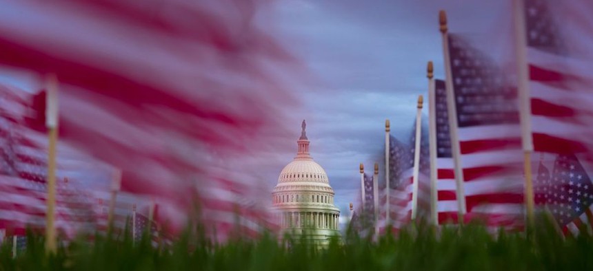 American flags planted to commemorate lung cancer victims fly in the wind along the National Mall on November 10, 2025 on Capitol Hill in Washington, DC. The Senate reached a deal late Sunday to fund the Government, aiming to end the longest shutdown in history.