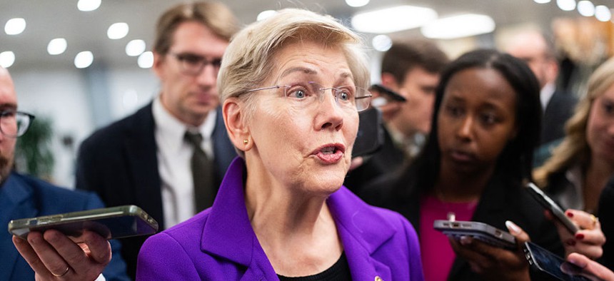 Sen. Elizabeth Warren, D-Mass., talks with reporters in the Senate subway on Tuesday, December 16, 2025.