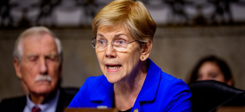 Sen. Elizabeth Warren (D-MA), accompanied by Sen. Angus King (I-ME) (L), speaks at a Senate Committee on Armed Services hearing on Capitol Hill on December 11, 2025 in Washington, DC.
