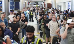 Travelers stand in long lines at Atlanta Hartsfield-Jackson International Airport on March 22, 2026. The travel disruptions continue as hundreds of TSA agents quit or work without pay during a partial government shutdown. President Donald Trump said ICE agents will be deployed to U.S. airports on Monday, with border czar Tom Homan in charge of the effort. 