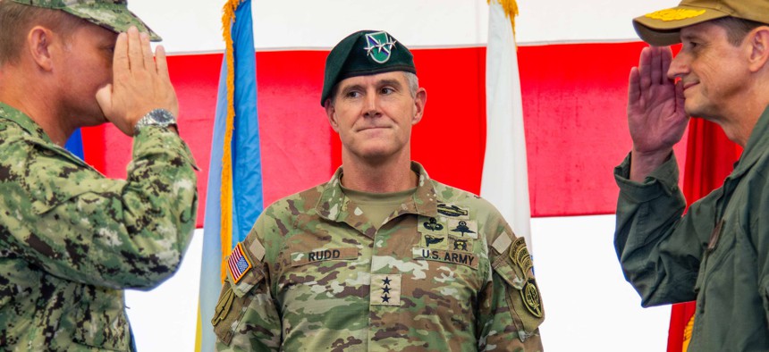 Lt. Gen. Joshua M. Rudd, then-deputy commander of U.S. Indo-Pacific Command, center, officiates a change of command ceremony at Marine Corps Base Camp Blaz Fitness Center, May 15, 2025.