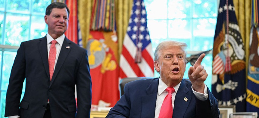 US President Donald Trump speaks after signing a presidential proclamation honoring the 90th anniversary of the Social Security Act, joined by Commissioner of the Social Security Administration Frank Bisignano (L) in the Oval Office of the White House in Washington, D.C., on August 14, 2025.