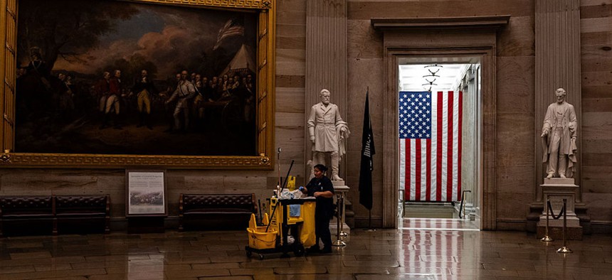 A maintenance worker pushes a cleaning cart through the rotunda of the U.S. Capitol on September 30, 2025 in Washington, D.C.