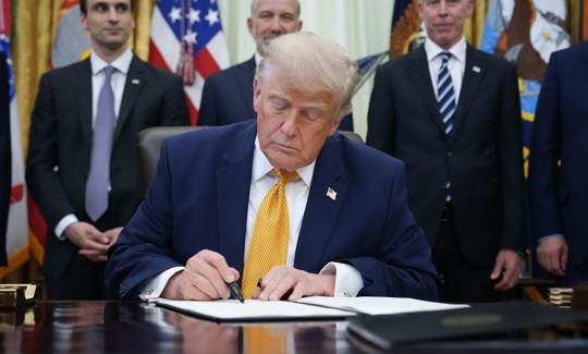 President Donald Trump signs an executive order in the Oval Office of the White House on June 22, 2026 in Washington, DC. 
