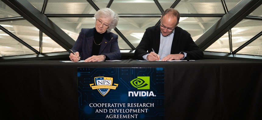 Retired U.S. Navy Vice Adm. Ann Rondeau, left, president of the Naval Postgraduate School (NPS) and NVIDIA Vice President of External Affairs Ned Finkle, right, sign a Cooperative Research and Development Agreement (CRADA) at NVIDIA Corporation’s headquarters in Santa Clara, California. 