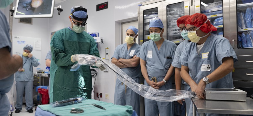 Dr. Matthew Willsey connects the internal and external transceivers to test the device diagnostics.