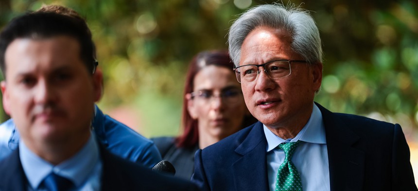 Nvidia CEO Jensen Huang talks to members of the press as he leaves the Hart Senate Office Building on July 28, 2026 in Washington, DC.