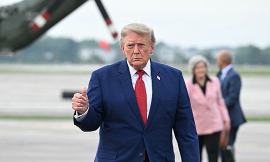 US President Donald Trump gives a thumbs up before boarding Air Force One en route back to Washington, DC, at Cleveland Hopkins International Airport in Cleveland, Ohio on August 11, 2026. 