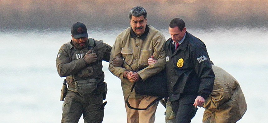 Nicolas Maduro and his wife, Cilia Flores, are seen in handcuffs after landing at a Manhattan helipad, escorted by heavily armed Federal agents as they make their way into an armored car en route to a Federal courthouse in Manhattan on January 5, 2026 in New York City.