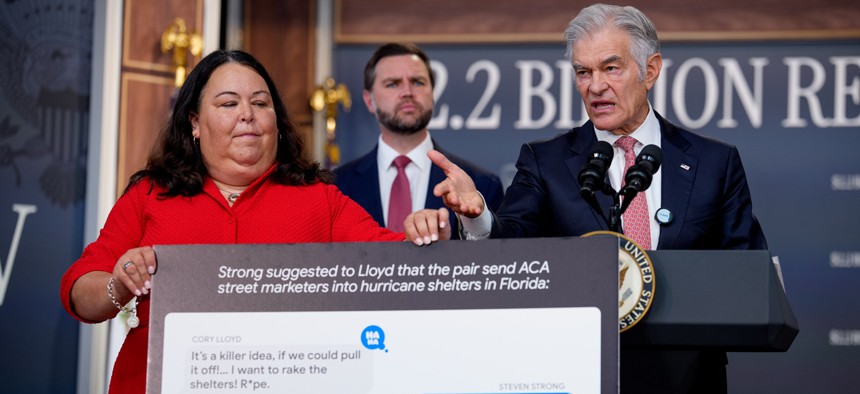 Vice President J.D. Vance (C) appears onstage as Deputy Administrator & Chief Operating Officer Kimberly Brandt (L) holds up a poster depicting a text conversation with Cory Lloyd, convicted of Affordable Care Act fraud, as Administrator for the Centers for Medicare & Medicaid Services Dr. Mehmet Oz (R), speaks during a news conference on fraud at the Eisenhower Executive Office Building on the White House Campus on September 22, 2026 in Washington, DC.