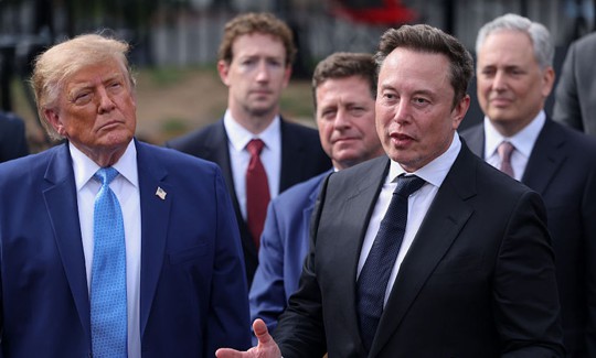 Tesla, X and SpaceX CEO Elon Musk speaks to reporters as US President Donald Trump looks on outside the White House on Tuesday, Sept. 29, 2026 in Washington, D.C. Trump held a meeting earlier that day on "super intelligence" with tech CEOs in the East Room.
